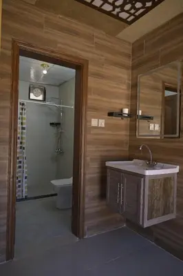 a bathroom with a sink and a toilet and a mirror at Wadi Rum Desert Secret in Wadi Rum