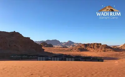 a view of the desert with a building in the foreground at Wadi Rum Starlight Camp in Wadi Rum