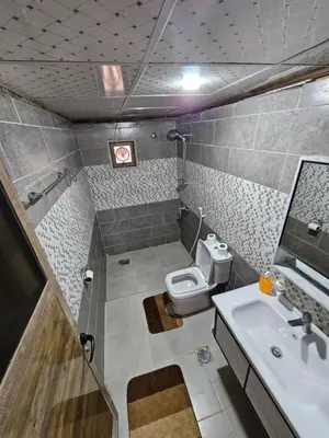 a small bathroom with a toilet and a sink at Wadi Rum Candles Camp in Wadi Rum