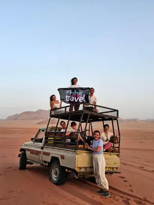 a group of people in a jeep in the desert at Wadi Rum Candles Camp in Wadi Rum