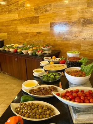 a buffet with many plates of food on a table at Esperanza Petra in Wadi Musa