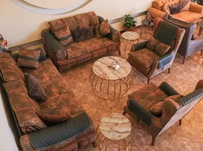 a living room with couches and chairs and tables at Esperanza Petra in Wadi Musa