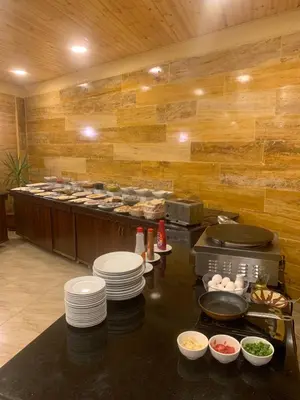 a kitchen with plates and bowls of food on a counter at Esperanza Petra in Wadi Musa