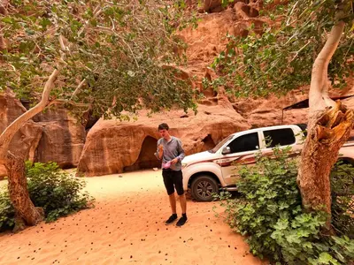 a man standing in front of a white truck at Stargazing Camp & Tours in Wadi Rum