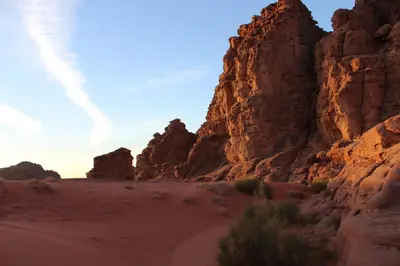 a desert scene with rocks and a dirt road at Rumshines Camp in Wadi Rum
