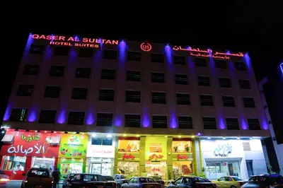a building with purple lights on top of it at Qaser Al-Sultan Hotel Suites in Amman