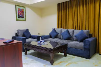 a living room with a couch and a coffee table at Qaser Al-Sultan Hotel Suites in Amman