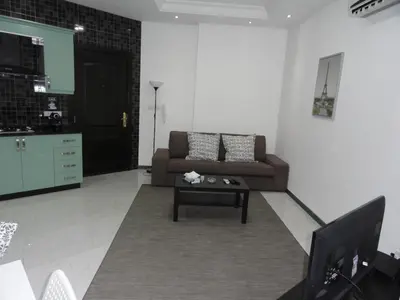 a living room with a couch and a coffee table at Diyarkom Apartment in Amman