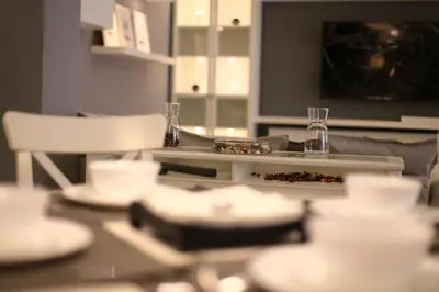 a table with plates and glasses on top of it at Elite Residency in Amman