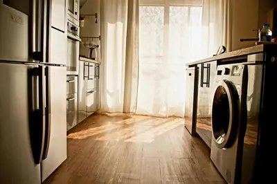 a kitchen with a washing machine and a window at Elite Residency in Amman