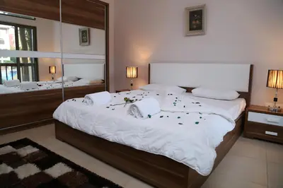 a bedroom with a large bed with flowers on it at Tala Bay Residence - Families Only in Aqaba