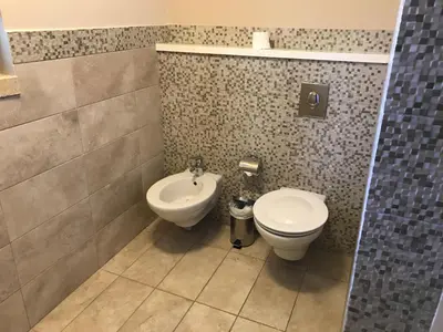a bathroom with a toilet and a bidet at Tala Bay Residence - Families Only in Aqaba