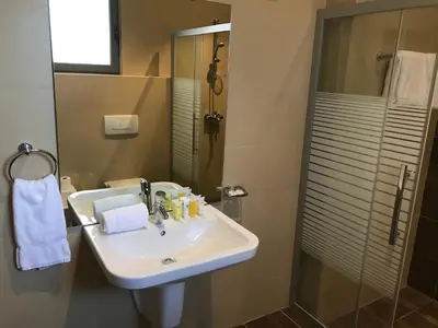 a bathroom with a sink and a shower at Tala Bay Residence - Families Only in Aqaba