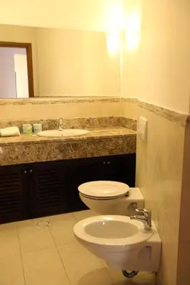 a bathroom with a toilet and a sink at Tala Bay Residence - Families Only in Aqaba