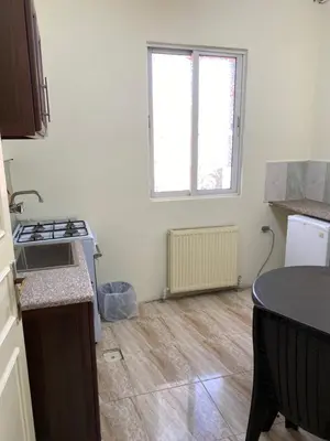 a kitchen with a sink and a stove top oven at Sami Apartments in Amman