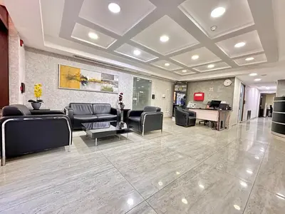 a waiting room with leather chairs and a desk at Margarita Hotel in Amman