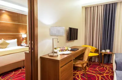 a hotel room with a desk and a bed at Gerasa Hotel in Amman
