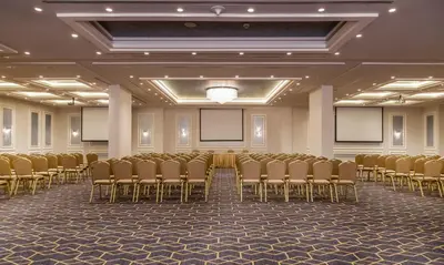 a room with a row of chairs and screens at Gerasa Hotel in Amman