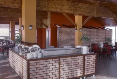 a restaurant with a counter with dishes on it at Mariam Hotel in Madaba