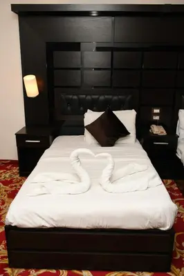a bed with a snake made out of pillows at Sparr Hotel in Amman
