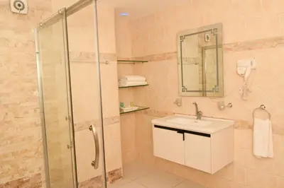 a bathroom with a shower and a sink at Sparr Hotel in Amman