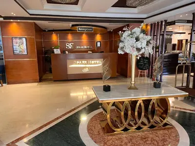 a lobby with a table with flowers on it at Sparr Hotel in Amman