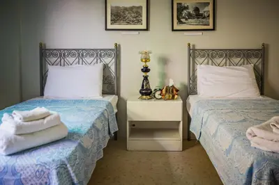 two beds sitting next to each other in a bedroom at Beit Al Baraka in Um Qeis