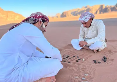 two men playing in the sand in the desert at Rum Planet Camp in Wadi Rum