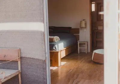 a bedroom with a bed and a room with a table at Rum Planet Camp in Wadi Rum