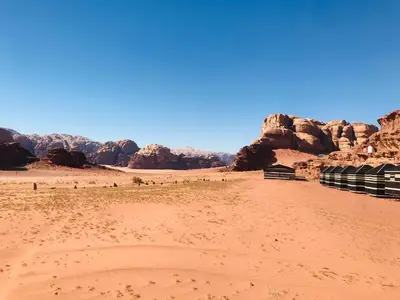 a desert with some rocks and a dirt field at Red Mountain Camp in Wadi Rum