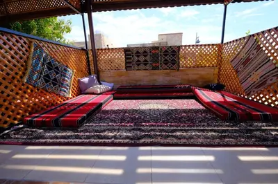 a porch with a hammock and a rug at Darna Divers Village in Aqaba