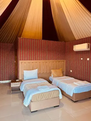 two beds sitting next to each other in a room at DESERT HELO lUXURY CAMP & TOUR in Wadi Rum