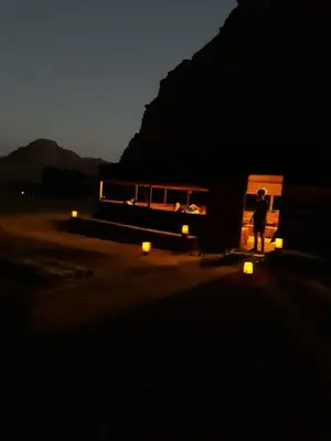 a person standing in front of a group of buses at Wadi Rum Nature Tours And Camp in Wadi Rum
