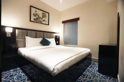 a bedroom with a large white bed in a room at Naylover Hotel Suites in Amman