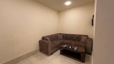 a living room with a couch and a table at Al Riyati Hotel Apartments in Aqaba