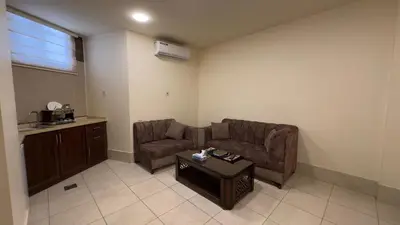 a living room with a couch and a coffee table at Al Riyati Hotel Apartments in Aqaba