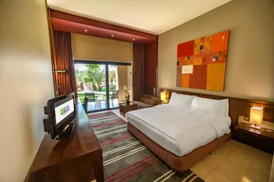a bedroom with a bed and a tv in it at Holiday Inn Resort Dead Sea by IHG in Sowayma