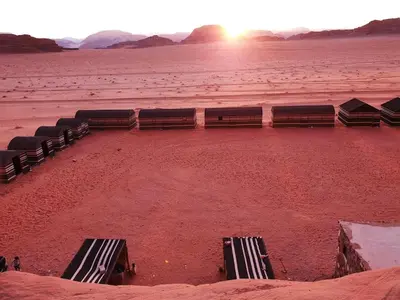 a group of benches sitting in the desert at Wadi Rum Desert Camp in Wadi Rum