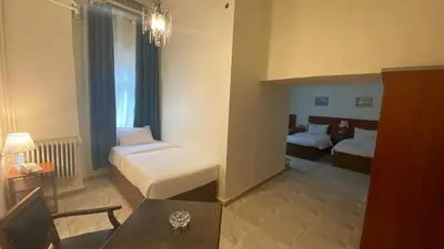 a hotel room with a bed and a living room at New Park Hotel in Amman