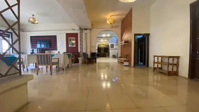 a large room with a table and chairs in it at New Park Hotel in Amman