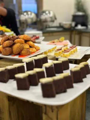 a table with several trays of chocolate and other desserts at Sharah Mountains Hotel in Wadi Musa