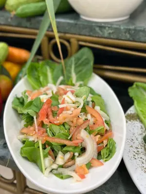 a salad in a white bowl on a table at Sharah Mountains Hotel in Wadi Musa