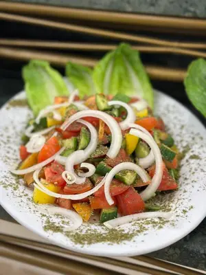 a plate of food with vegetables on a table at Sharah Mountains Hotel in Wadi Musa