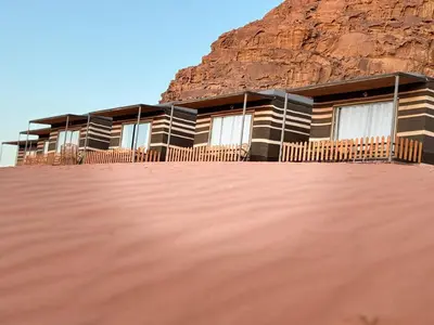 a house in the middle of a desert with a mountain at Beauty Wadi Rum Luxury Camp in Wadi Rum