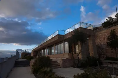 a building with a balcony on top of it at Sindyan Resort in Amman