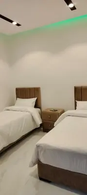 two beds sitting next to each other in a bedroom at Mussa Spring Hotel in Wadi Musa
