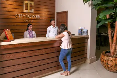 a woman is standing at a counter in a store at City Tower Hotel in Aqaba