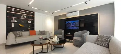 a living room with couches and tables and a tv at Al Kawther Hotel Apartments in Amman