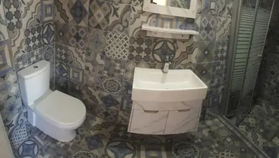 a bathroom with a sink and a toilet at Jordan Tower Hotel in Amman