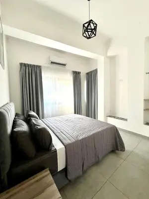 a bedroom with a large bed and a window at Jordan Tower Hotel in Amman